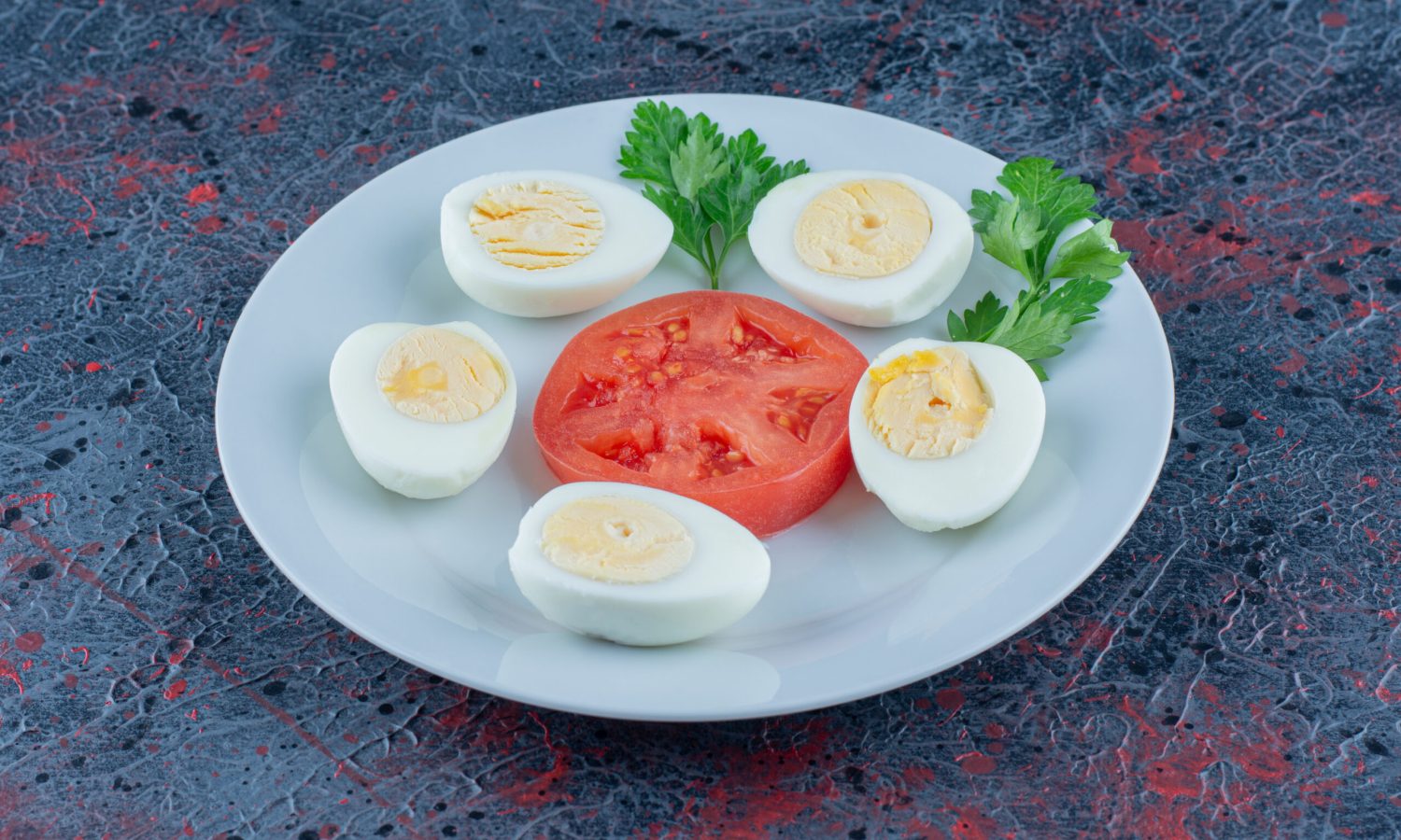 A blue plate of hard boiled eggs with vegetables body fat