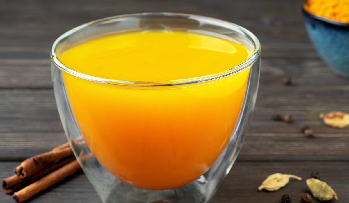 Cup with natural healthy herbal tea made from turmeric, honey and spices. Drink to support immunity against influenza and the common cold. The concept of medicine and a healthy lifestyle. Close-up Cup with natural healthy herbal tea made from turmeric, honey and spices. Drink to support immunity against influenza and the common cold. The concept of medicine and a healthy lifestyle. Close-up