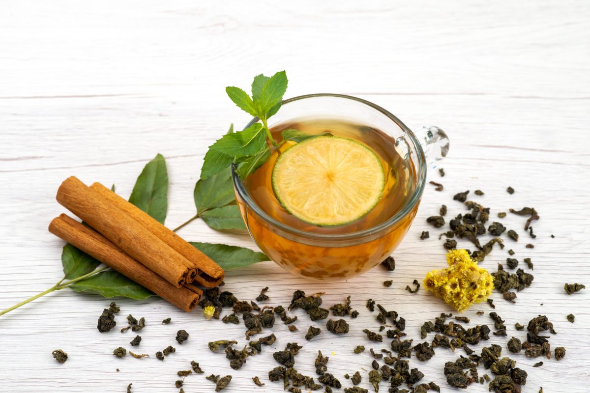 front-view-cup-tea-with-lemon-mint-cinnamon-white-tea-dessert-candy digestion