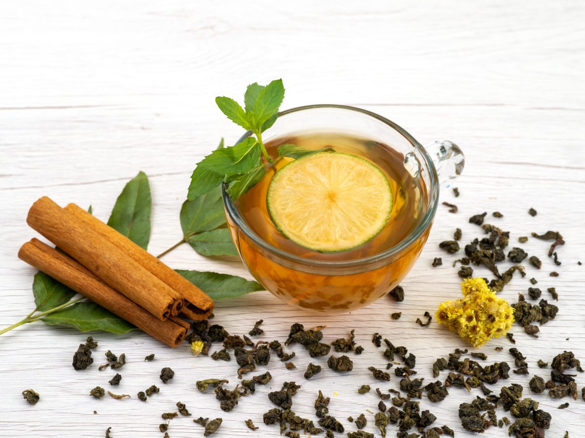 front-view-cup-tea-with-lemon-mint-cinnamon-white-tea-dessert-candy digestion