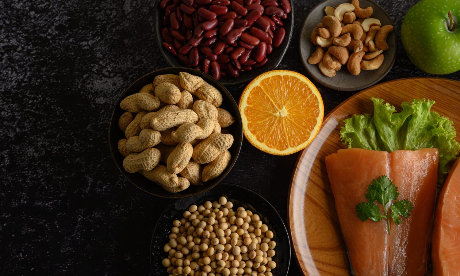 Legumes, fruit and salmon pieces on a wooden plate. Legumes, fruit and salmon pieces on a wooden plate.