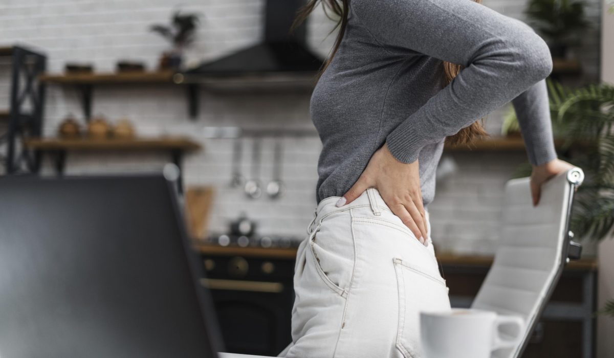 side-view-woman-having-backache-while-working-from-home lower back pain