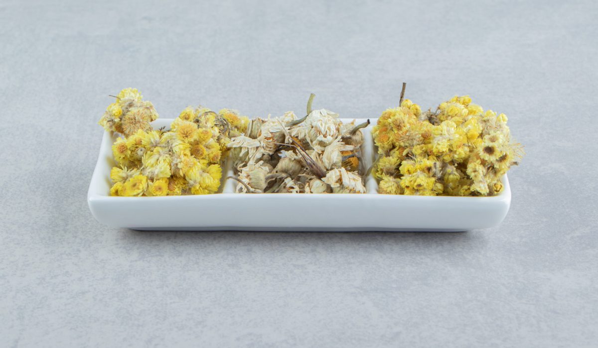 Variety of dry flowers on white plate hormonal balance